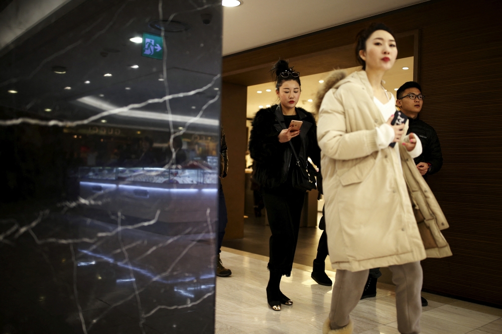 Chinese tourists shop at a Lotte duty free shop in central Seoul, South Korea, February 2, 2016. REUTERS/Kim Hong-Ji/File Photo