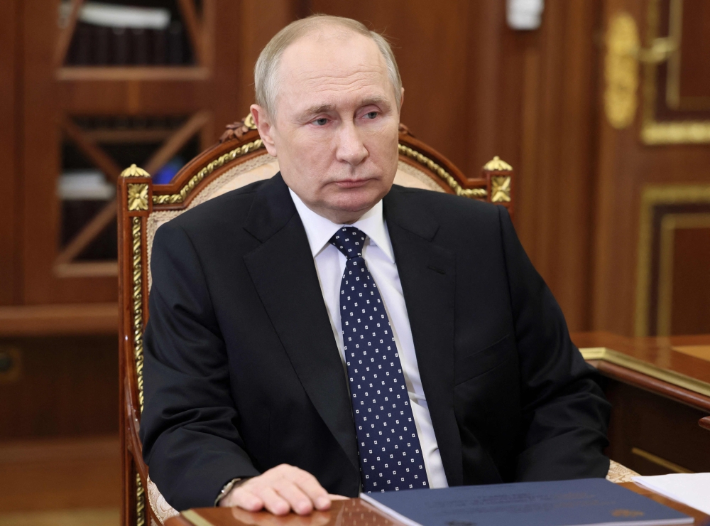Russian President Vladimir Putin speaks with head of the Russia's Karachay-Cherkessia Republic during their meeting in Moscow on January 5, 2023. (Photo by Mikhail Klimentyev / Sputnik / AFP)