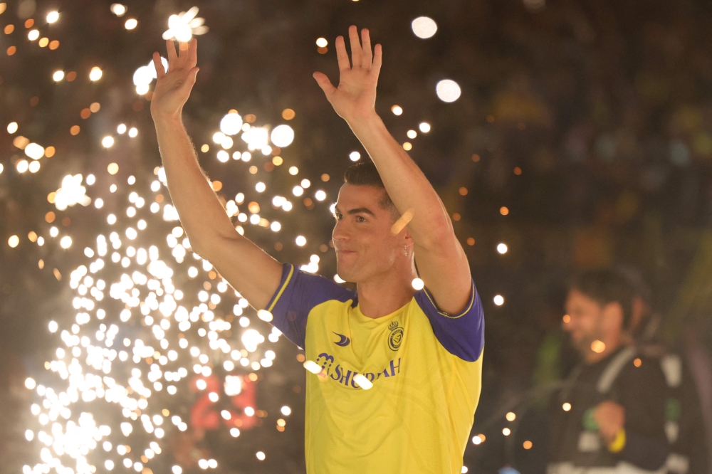 Al-Nassr's new Portuguese forward Cristiano Ronaldo greets the fans during his unveiling at the Mrsool Park Stadium in the Saudi capital Riyadh on January 3, 2023. (Photo by Fayez Nureldine / AFP)
 
