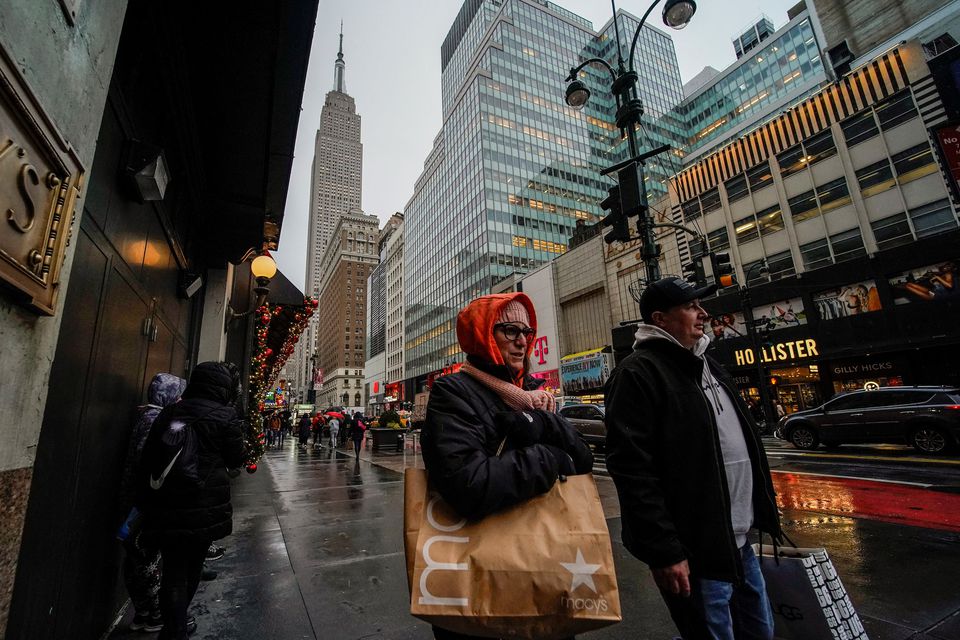 People carry shopping bags during the holiday season in New York City, US, on December 15, 2022. File Photo / Reuters