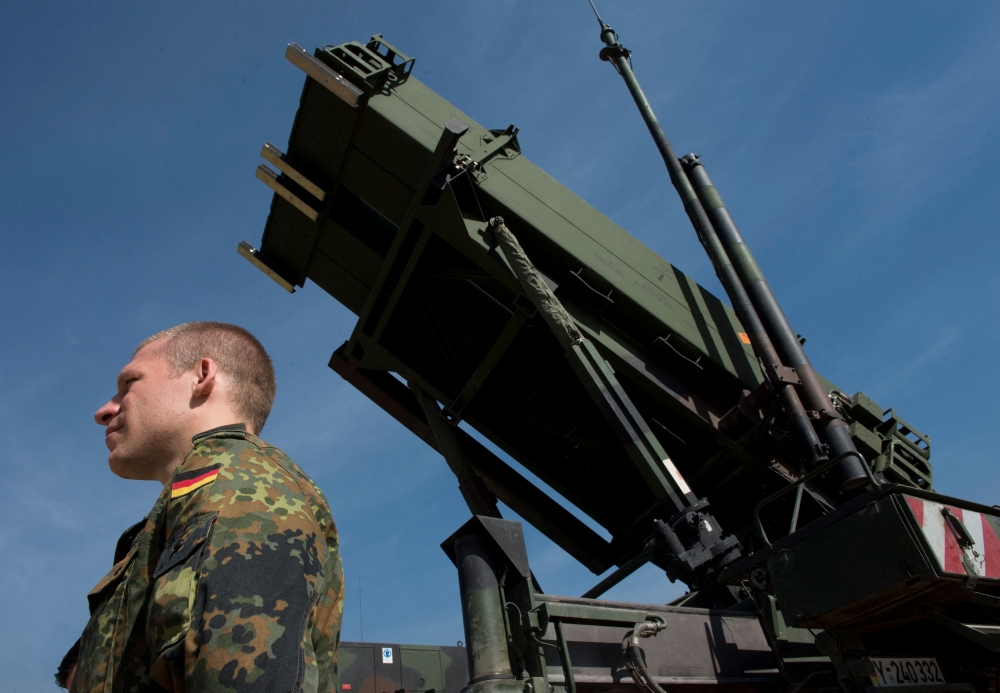 In this file photo taken on March 25, 2014, a German soldier stands to attention in front of a German Patriot missile launcher at the Gazi barracks in Kahramanmaras, southern Turkey, on March 25, 2014. (Photo by John MacDougall / AFP)