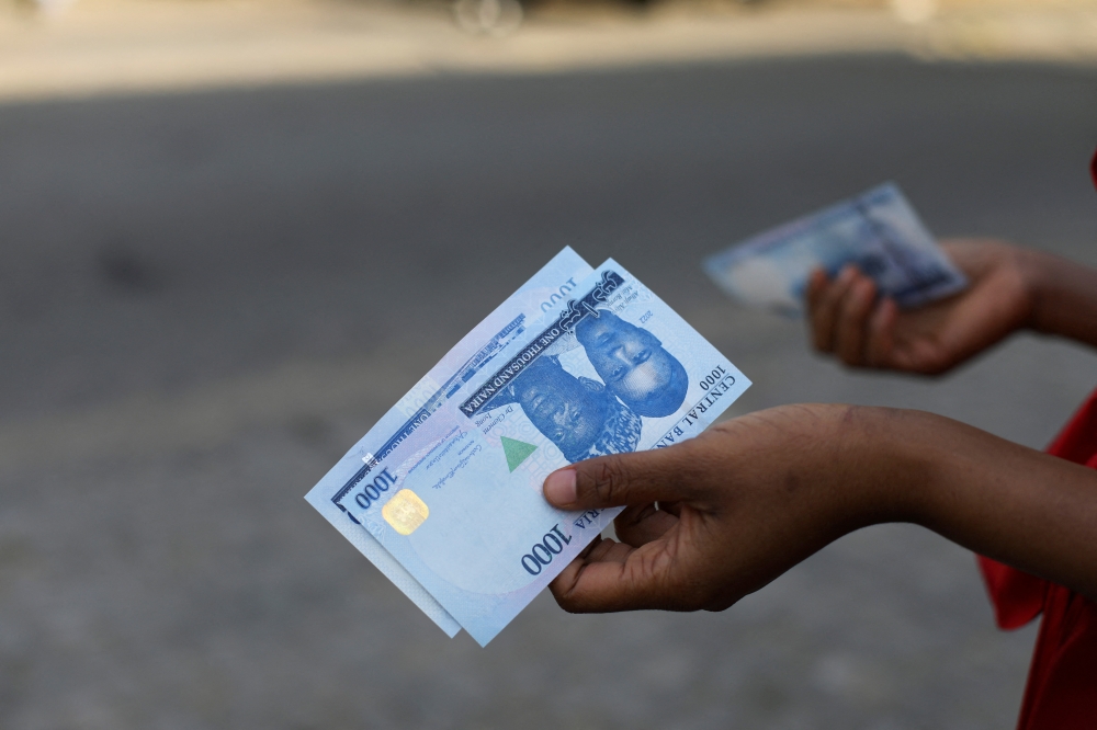 A person holds a new 1000 Naira note as the Central Bank of Nigeria releases the notes to the public through the banks in Abuja, Nigeria, December 15, 2022. (REUTERS/Afolabi Sotunde)