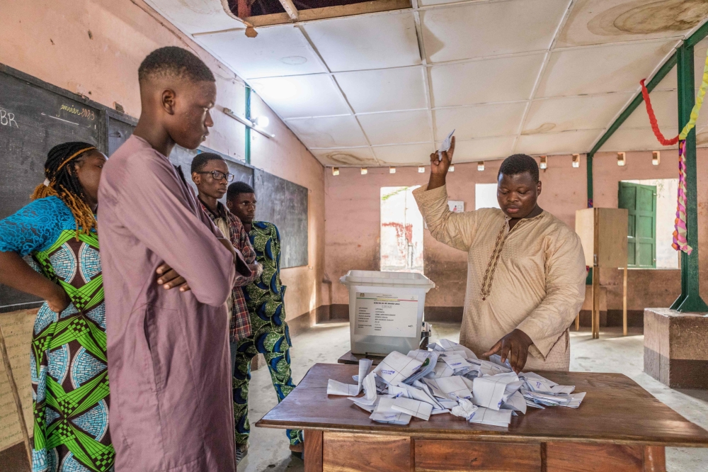 Members of the observers and the CENA (Commission Electorale Nationale Autonome) check the number of votes following the legislative elections at the public primary school, Charles Guillot de Zongo in Cotonou on January 8, 2023. (Photo by Yanick Folly / AFP)