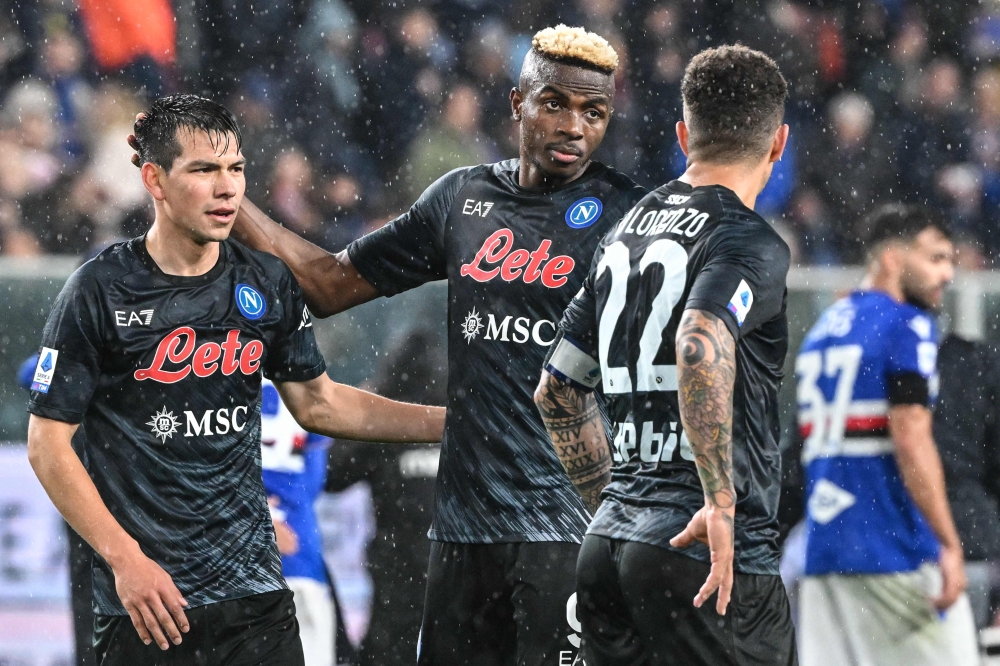 Napoli's Mexican forward Hirving Lozano (left) and Napoli's Nigerian forward Victor Osimhen react at the end of the Italian Serie A match between Sampdoria and Napoli on January 8, 2023 at the Luigi-Ferraris stadium in Genoa. (Photo by Andreas SOLARO / AFP)