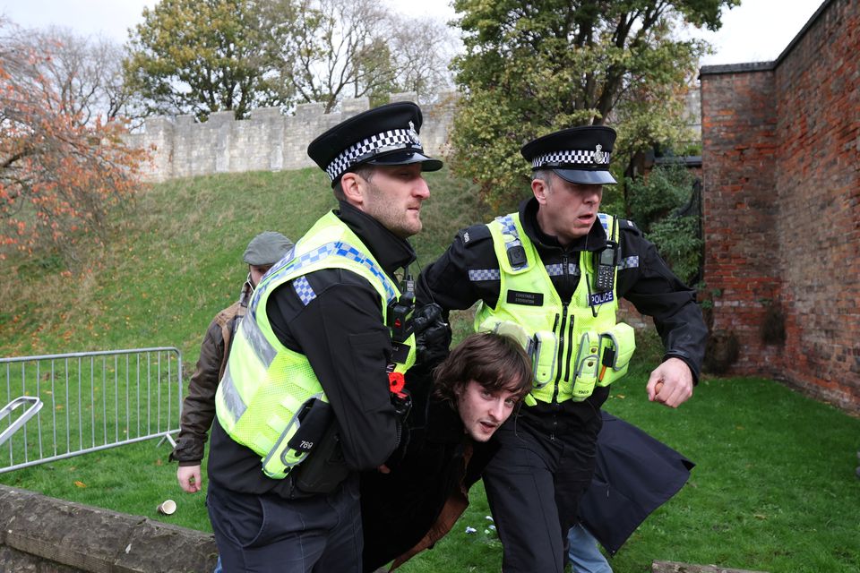 File Photo: Police officers restrain a man who threw an egg at King Charles during his visit to Micklegate bar in York, Britain, November 9, 2022. (REUTERS/Russell Cheyne)

