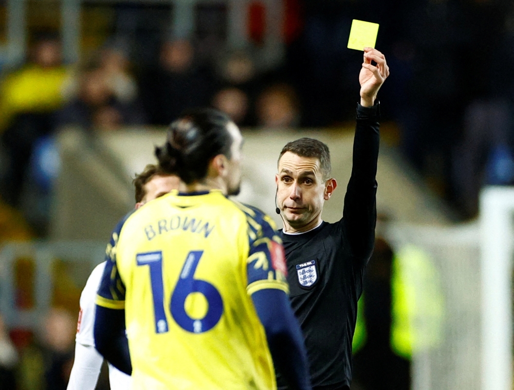 Oxford United's Ciaron Brown is shown a yellow card by referee David Coote during the FA Cup third round match v Arsenal at the Kassam Stadium, Oxford, Britain on January 9, 2023. Action Images via Reuters/John Sibley/File Photo