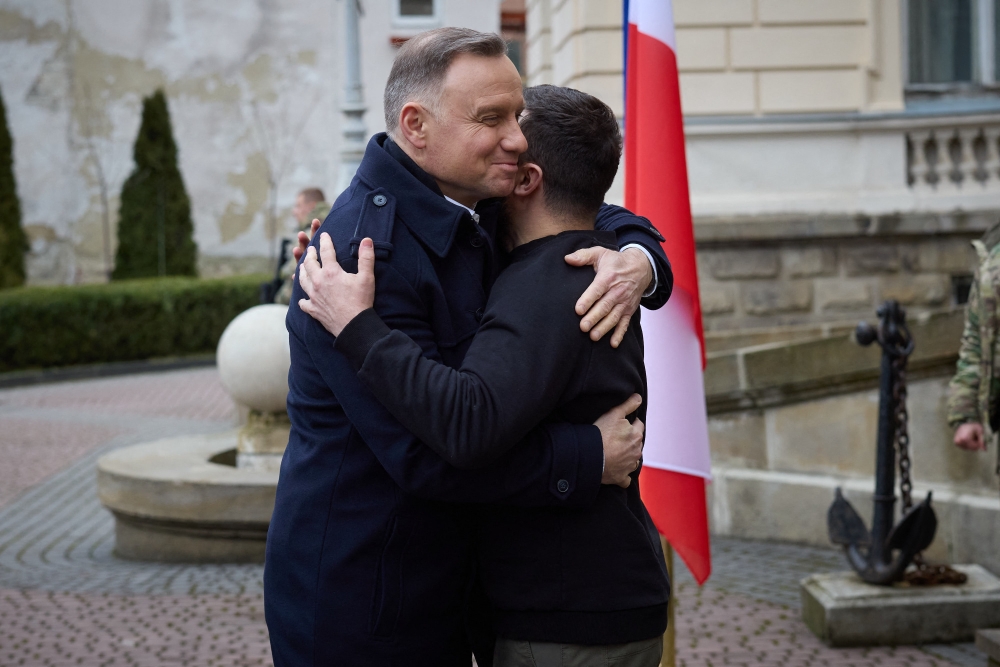 In this handout picture taken and released on January 11, 2023, Ukrainian President Volodymyr Zelensky (right) welcomes his Polish counterpart Andrzej Duda prior to the second summit of the Lublin Triangle held in the western Ukrainian city of Lviv. (Photo by HANDOUT / UKRAINIAN PRESIDENTIAL PRESS SERVICE / AFP)