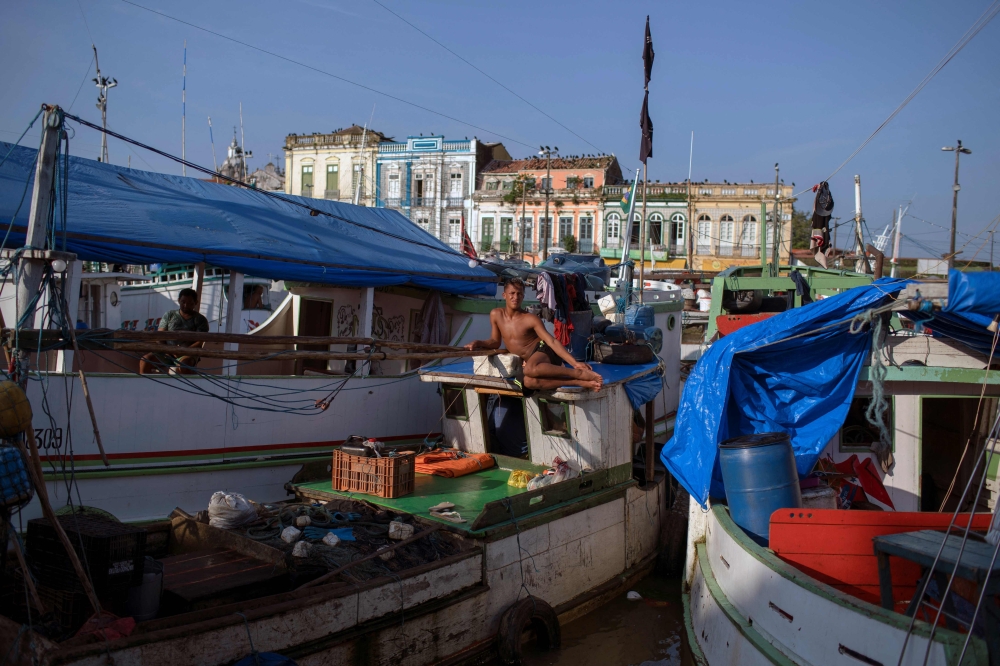 In this file photo taken on September 17, 2021, a fisherman is seen on a fish boat docked at the Ver-o-Peso popular market in Belem, Para state, Brazil. (AFP)