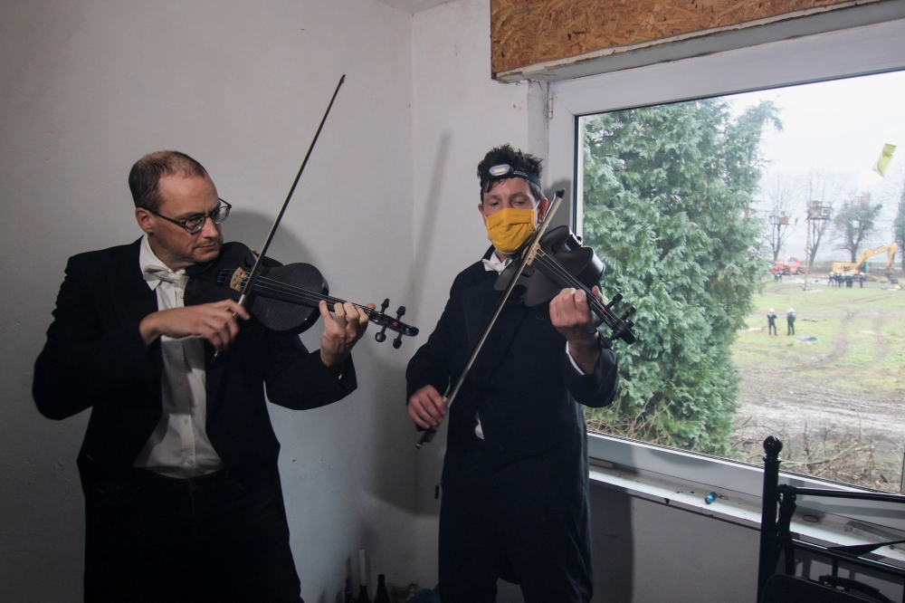 Musicians Thomas Gerlinger, 54, and Luppe, over 50, play violin and viola in an abandoned house in protest against demolishing Luetzerath village to expand the Garzweiler open-cast lignite mine of Germany's utility RWE, in Luetzerath, Germany, on January 12, 2023.
