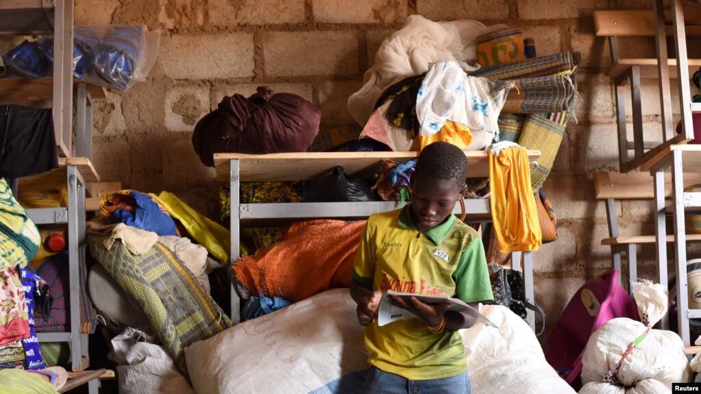 A displaced boy, who fled with others from his village in northern Burkina Faso following attacks by assailants, poses at a school on the outskirts of Ouagadougou, Burkina Faso, on June 15, 2019.  File Photo / Reuters
