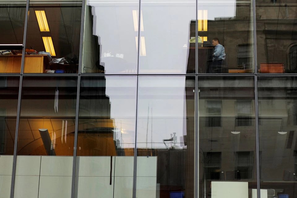 A worker sits at his desk in an office building in Washington, U.S., August 3, 2018. REUTERS/Brian Snyder/File Photo
