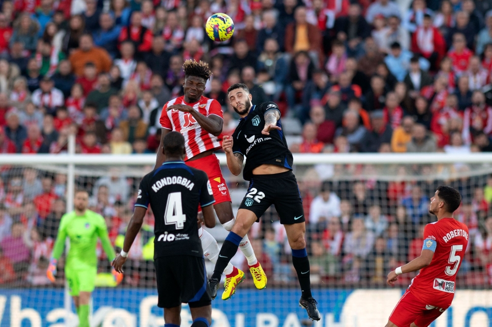 Almeria's Malian forward El Bilal Toure (top-left) and Atletico Madrid's Spanish defender Mario Hermoso jump for the ball during the Spanish League football match between UD Almeria and Club Atletico de Madrid at the Mediterranean Games Municipal Stadium in Almeria on January 15, 2023. (Photo by JORGE GUERRERO / AFP)