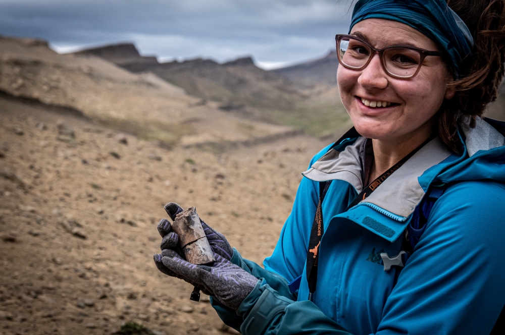 A woman holds a fossil at the area where scientists discovered megaraptor fossils at 'Guido' hill in the Chilean Patagonia area, close to Torres del Paine park, in Magallanes and Antarctic region, Chile in this undated handout photo provided by the Instituto Chileno Antartico on January 16, 2023. (Instituto Chileno Antartico/Handout via REUTERS) 