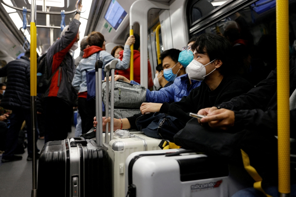 Travellers take the first train to Hong Kong's Lok Ma Chau border checkpoint on the first day China reopens the border amid the coronavirus disease (COVID-19) pandemic in Hong Kong, China, January 8, 2023. REUTERS/Tyrone Siu/File Photo