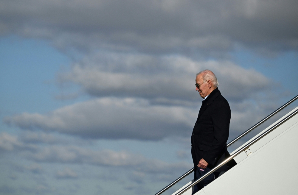 US President Joe Biden steps off Air Force One at Moffett Federal Airfield, NASA Ames Research Center Boundary, in Mountain View, California, on January 19, 2023. (Photo by ANDREW CABALLERO-REYNOLDS / AFP)