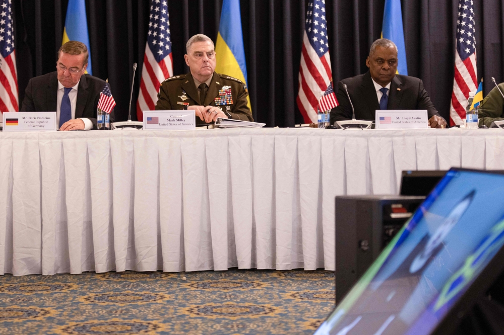 (From left) German Defence Minister Boris Pistorius, US General Mark Milley, and US Secretary of Defence Lloyd Austin listen to a video message from Ukrainian President Volodymyr Zelensky during the Ukraine Defense Contact Group meeting at Ramstein Air Base in Ramstein-Miesenbach, southwestern Germany on January 20, 2023. (Photo by Andre Pain / AFP)