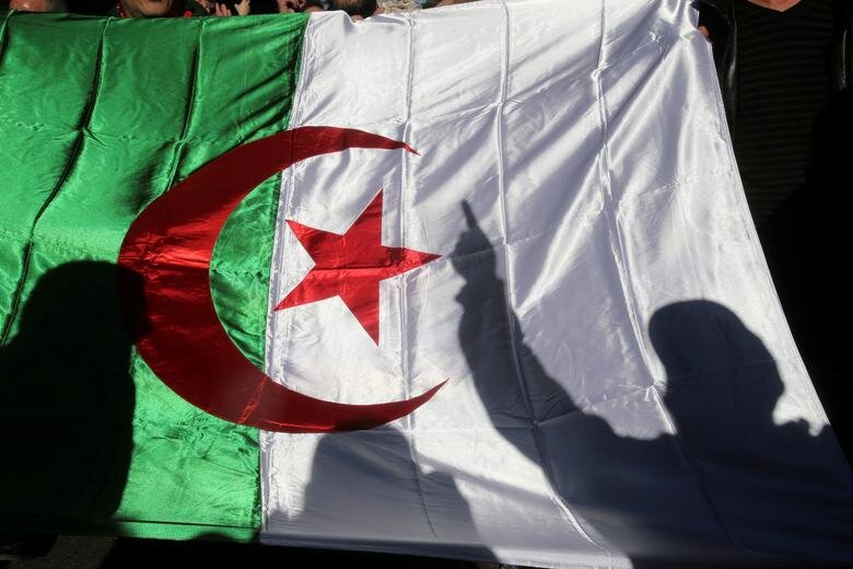A demonstrator's shadow is cast on a national flag during an anti-government rally in Algiers, Algeria on December 24, 2019. File Photo / Reuters
