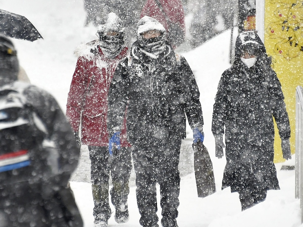 Pedestrians walk through the snow in Otaru, Hokkaido, on Saturday. Japan News-Yomiuri.
