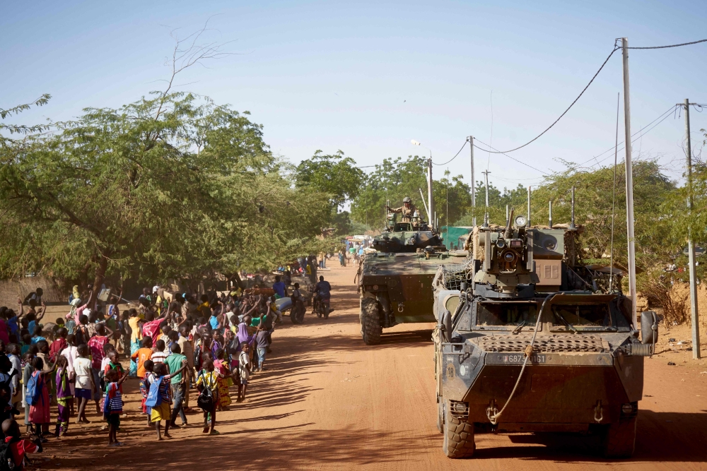 In this file photo taken on November 14, 2019, soldiers of the French Army patrols the village Gorom Gorom in Armoured Personnel Carriers during the Barkhane operation in northern Burkina Faso. (Photo by MICHELE CATTANI / AFP)