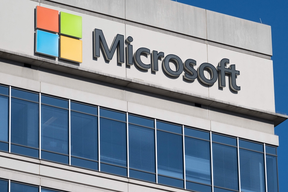 In this file photo taken on January 18, 2023 a sign outside a building with offices belonging to Microsoft is seen in Chevy Chase, Maryland. - Microsoft on January 23, 2023 said it had extended its partnership with OpenAI, the research lab and creator of ChatGPT, an artificial intelligence chatbot that has sparked widespread fears of cheating in schools and universities. (Photo by SAUL LOEB / AFP)
 