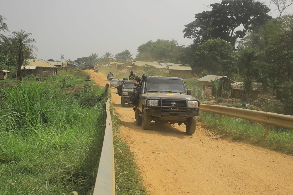 In this file photo taken on March 19, 2022, a convoy of FARDC (Armed Forces of the Democratic Republic of Congo) soldiers on the Loya bridge on the Beni-Komanda axis considered as the axis of death in the chiefdom of Walese Vonkutu. (Photo by Sébastien Kitsa Musayi / AFP)