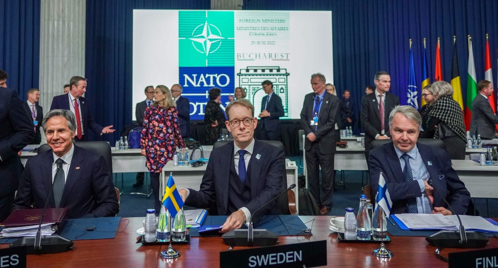 In this file photo taken on November 29, 2022 (left-right) US Secretary of State Antony Blinken, Sweden's Foreign Minister Tobias Billstrom and Finland's Foreign Minister Pekka Haavisto sit at their places prior to the start of a meeting of the North Atlantic Council (NAC) in the framework of a NATO Foreign Ministers session, with invitees from Finland and Sweden, in Bucharest, Romania. (Photo by Andrei PUNGOVSCHI / AFP)
 
