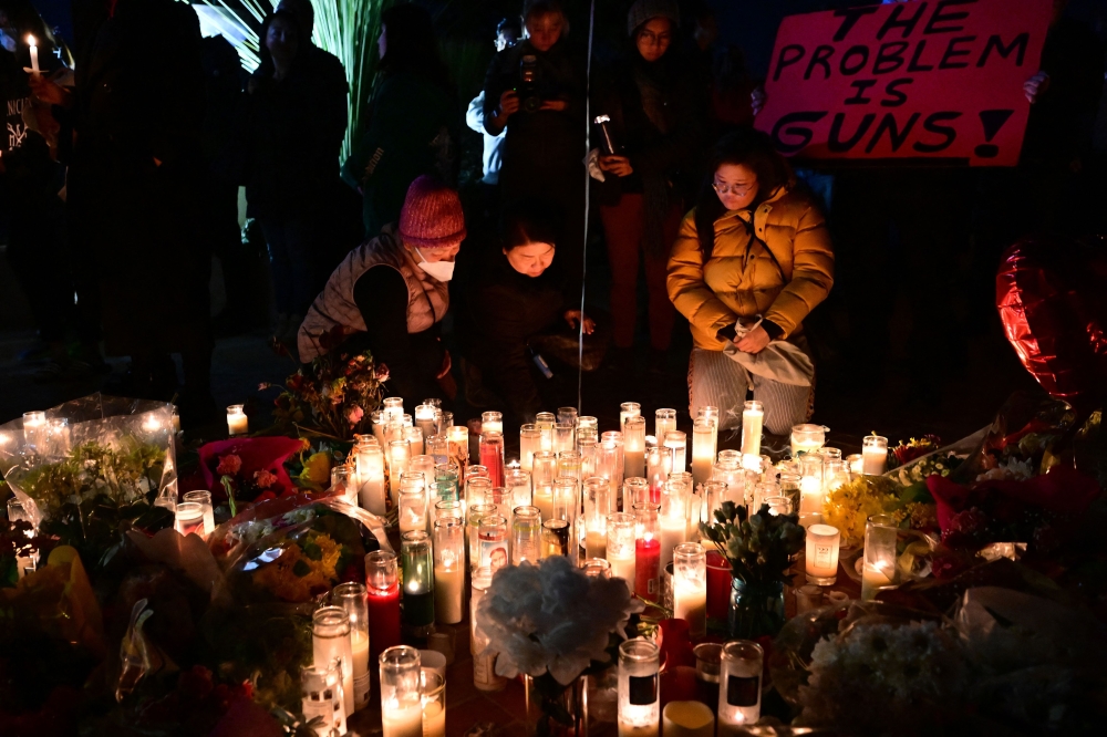 People pay tribute to the victims of the mass shooting at a candlelight vigil in front of City Hall in Monterey Park, California, on January 24, 2023. Photo by Frederic J. Brown / AFP