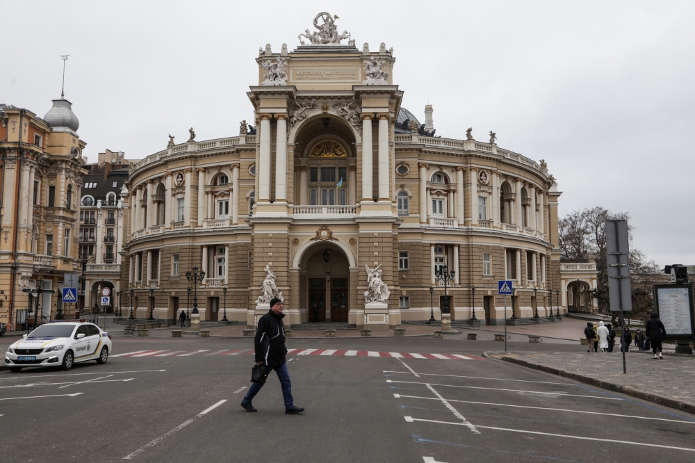 A man walks next to the Opera Theatre building in the city centre, amid Russia's attack on Ukraine, in Odesa, Ukraine, January 25, 2023. (REUTERS/Serhii Smolientsev)