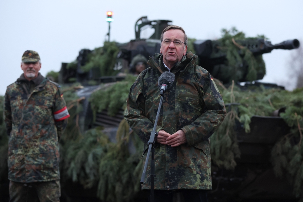 German Defence Minister Boris Pistorius stands in front of a Puma tank as he addresses troops of the German armed forces Bundeswehr at a military training area in Altengrabow near Moeckern, eastern Germany, on January 26, 2023. (Photo by Ronny HARTMANN / AFP)