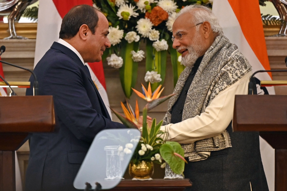 Egypt's President Abdel Fattah al-Sisi (left) shakes hands with India's Prime Minister Narendra Modi after their joint media briefing at the Hyderabad House in New Delhi on January 25, 2023. (Photo by Sajjad Hussain / AFP)