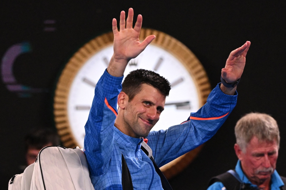 Serbia's Novak Djokovic waves as he leaves after victory against Tommy Paul of the US during their men's singles semi-final match on day twelve of the Australian Open tennis tournament in Melbourne on January 27, 2023. (Photo by WILLIAM WEST / AFP) 