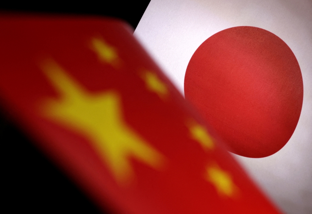 Printed Chinese and Japanese flags are seen in this illustration, July 21, 2022. REUTERS/Dado Ruvic/Illustration/File Photo
 