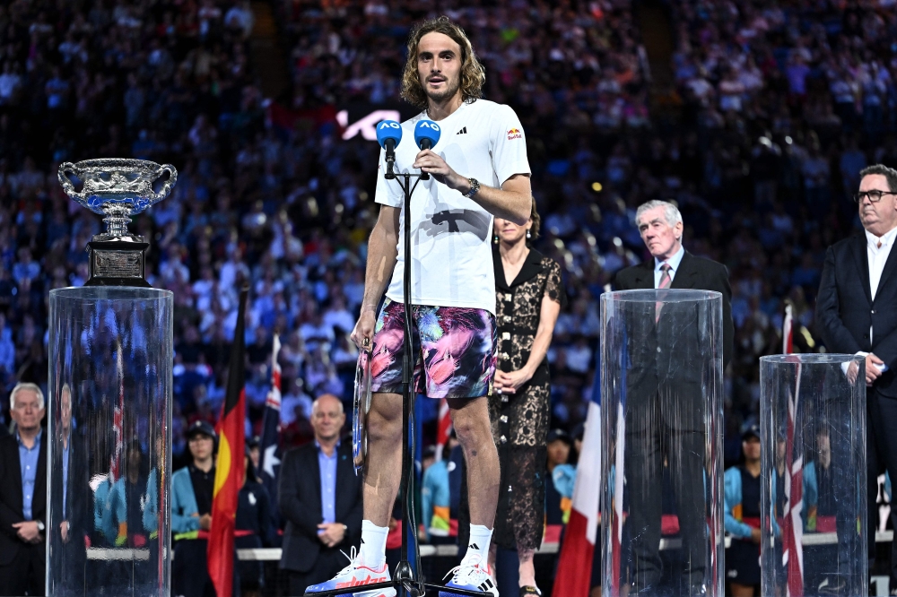 Greece's Stefanos Tsitsipas speaks during a trophy ceremony after his men's singles final match against Serbia's Novak Djokovic on day fourteen of the Australian Open tennis tournament in Melbourne on January 29, 2023. (Photo by MANAN VATSYAYANA / AFP)