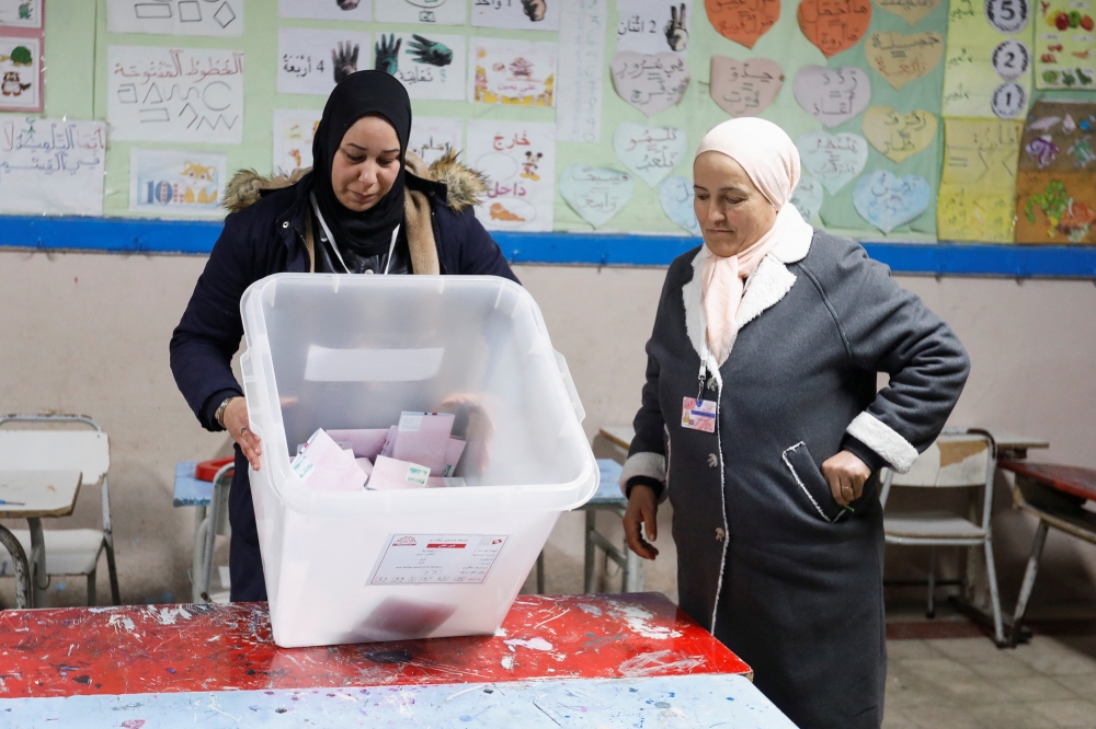 Members of the election committee empty a ballot box to count votes at a polling station during the second round of the parliamentary election in Tunis, Tunisia on January 29, 2023. REUTERS/Zoubeir Souissi