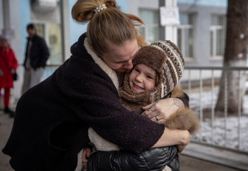 Mother Halyna, 24, hugs her daughter Arina, 6, after her evacuation from front line city of Bakhmut. Reuters/Oleksandr Ratushniak