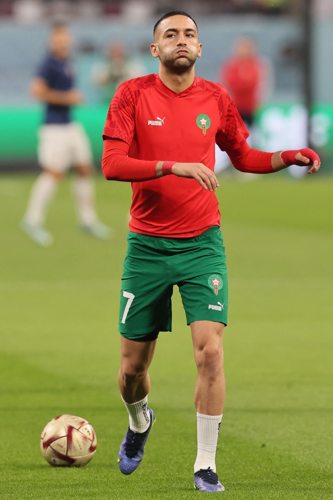 In this file photo taken on December 17, 2022 Morocco's midfielder Hakim Ziyech warms up prior to the Qatar 2022 World Cup third place play-off football match between Croatia and Morocco at Khalifa International Stadium in Doha. - The arrival of renowned Moroccan striker Hakim Ziyech at Paris SG was not approved in time for the end of the winter transfer window. (Photo by KARIM JAAFAR / AFP)