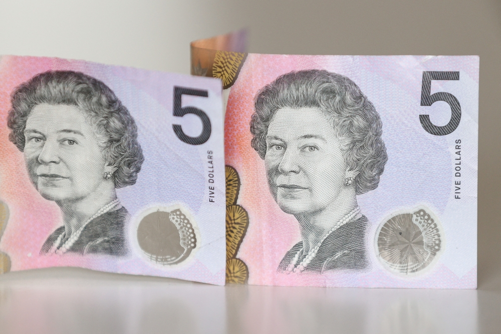 Australian $5 banknotes with a portrait of the late Queen Elizabeth II are seen in this picture illustration taken February 2, 2023. REUTERS/Loren Elliott/Illustration