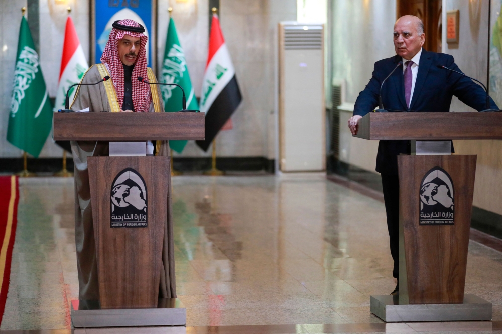 Iraq's Foreign Minister Fuad Hussein (R) listens as his Saudi counterpart Faisal bin Farhan speaks during a joint press conference in Baghdad on February 2, 2023. (Photo by Ahmad AL-RUBAYE / AFP)