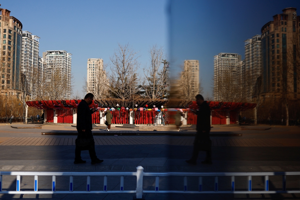 A person walks on a street in Beijing, China February 3, 2023. REUTERS/Tingshu Wang