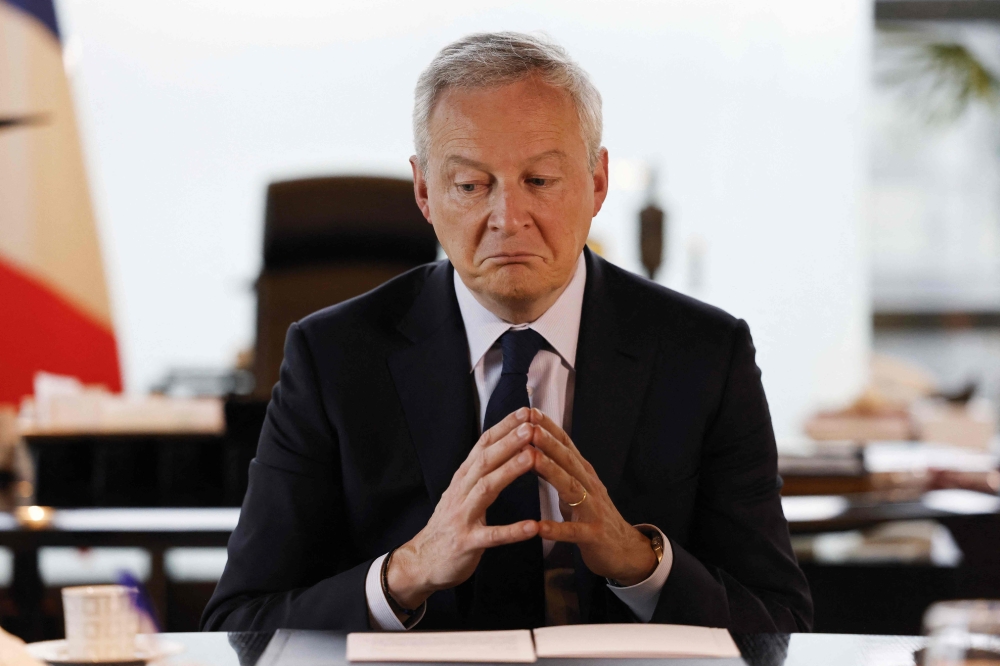French Economy Minister Bruno Le Maire gestures as he speaks to the press in the minister's office, in Paris, on February 3, 2023. (Photo by Ludovic Marin / AFP)