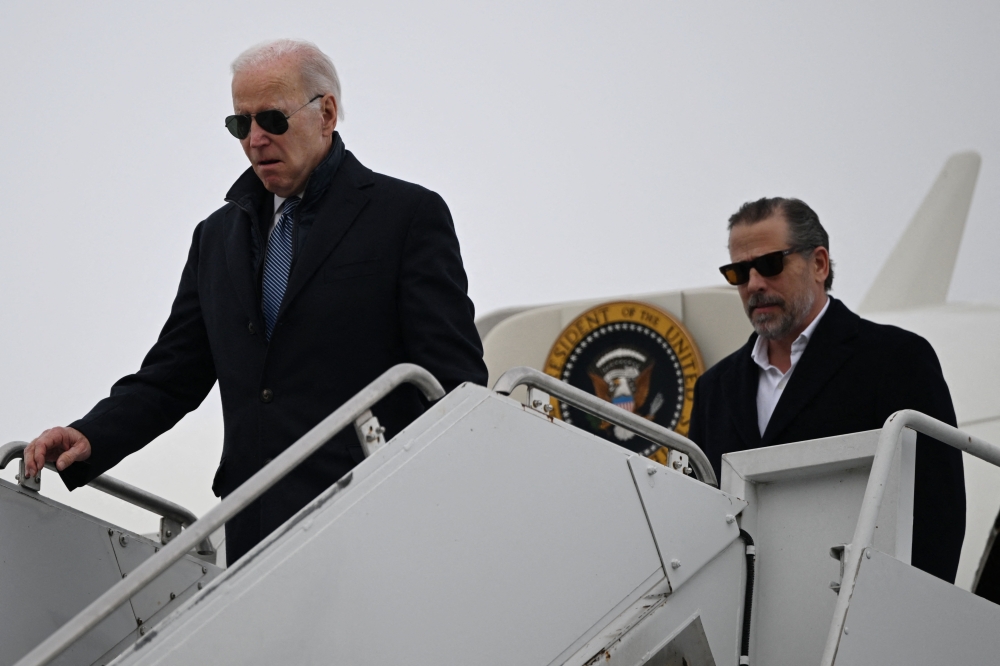 US President Joe Biden, with son Hunter Biden, arrives at Hancock Field Air National Guard Base in Syracuse, New York, on February 4, 2023. (Photo by ANDREW CABALLERO-REYNOLDS / AFP)