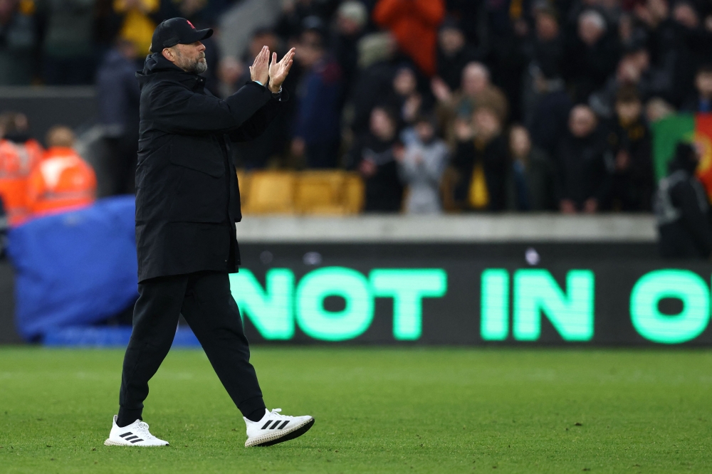 Liverpool's German manager Jurgen Klopp applauds at the end of the English Premier League football match between Wolverhampton Wanderers and Liverpool at the Molineux stadium in Wolverhampton, central England on February 4, 2023. (Photo by DARREN STAPLES / AFP)