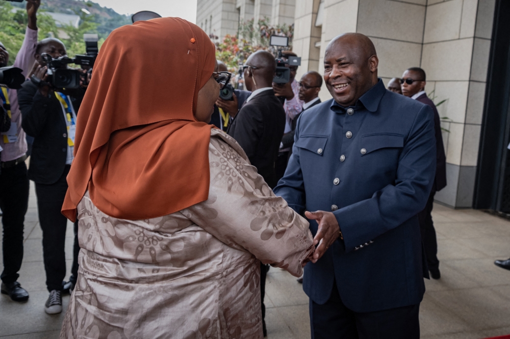 Tanzanian President Samia Suluhu Hassan (left) is greeted by Burundi's President Evariste Ndayishimiye as he arrives for the extraordinary Summit of East African Community Heads of State at the state house in Bujumbura, Burundi, on February 4, 2023.  (Photo by Tchandrou Nitanga / AFP)