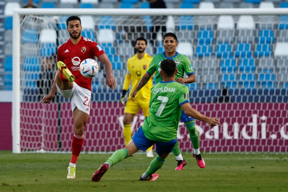 Ahly's Egyptian defender Mohamed Abdelmonem (left) is marked by Seattle Sounders' American midfielder Cristian Roldan during the FIFA Club World Cup second round match between Seattle Sounders FC and Egypt's Al-Ahly at the Ibn Batouta Stadium in Tangier on February 4, 2023. (Photo by Khaled DESOUKI / AFP)