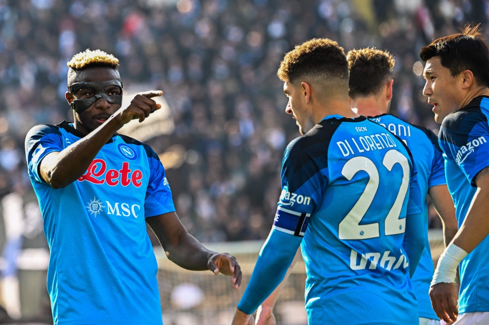 Napoli's Nigerian forward Victor Osimhen (left) celebrates after scoring during the Italian Serie A football match between Spezia and Napoli on February 5, 2023 at the Alberto-Picco stadium in La Spezia. (Photo by Alberto PIZZOLI / AFP)