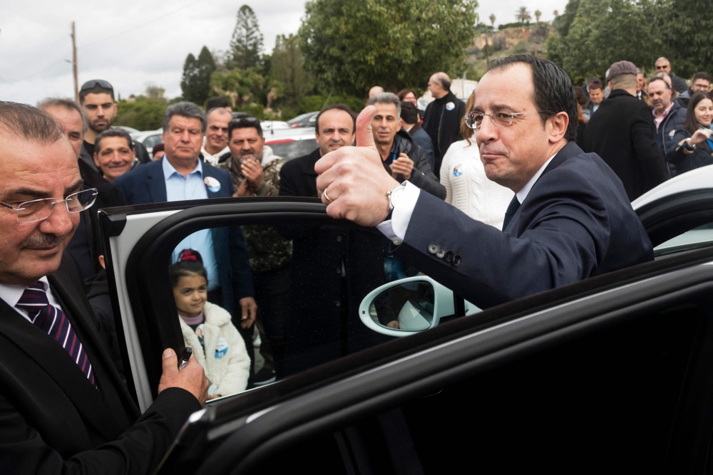 Former Cypriot foreign minister and presidential candidate Nikos Christodoulides greets supporters at the Geroskypou polling centre in the western Paphos district, on February 5, 2023. (Photo by Iakovos Hatzistavrou / AFP)