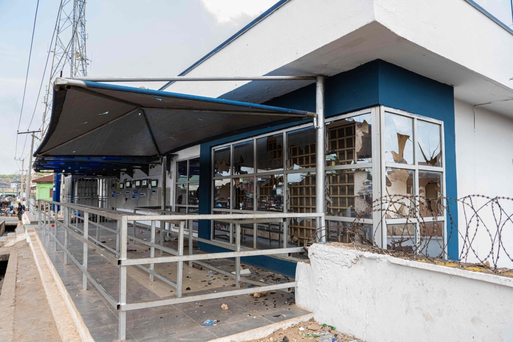 Debris are seen outside the premises of a local bank in Abeokuta, Nigeria, on February 7, 2023 after a demonstration by angry residents. - Angry protesters went on rampage on Tuesday in southwest Nigerian city of Abeokuta, in Ogun state, police and residents said, in the latest flare-up over a major cash and fuel crisis.  (Photo by Seun Adeniyi / AFP)