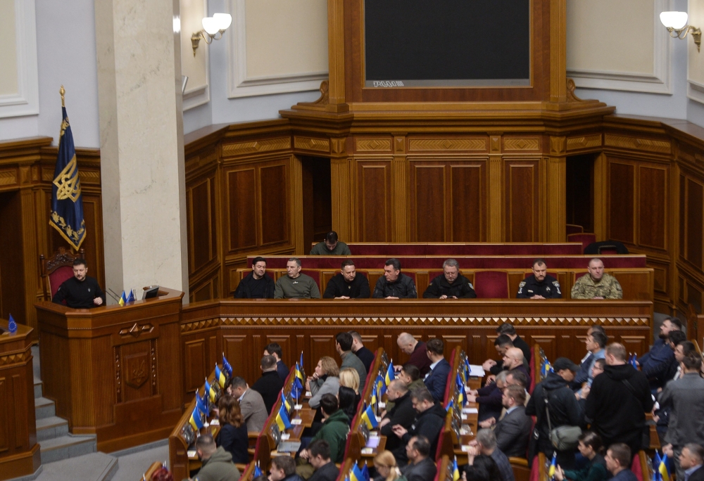 Ukraine's acting Minister of Internal Affairs Ihor Klymenko (2R/REAR) and acting Head of Security Service of Ukraine Vasyl Maliuk (R/REAR), attend a session of the Ukrainian Parliament with Ukraine's President Volodymyr Zelensky (L) where deputies will vote on the appointment in Kyiv on February 7, 2023, amid the Russian invasion of Ukraine. (Photo by ANDRII NESTERENKO / AFP)