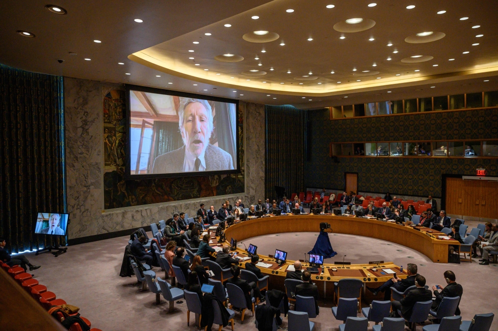 British musician Roger Waters is displayed on a screen during an address to a UN Security Council meeting on Ukraine, at UN headquarters in New York on February 8, 2023. (Photo by Ed Jones / AFP)
