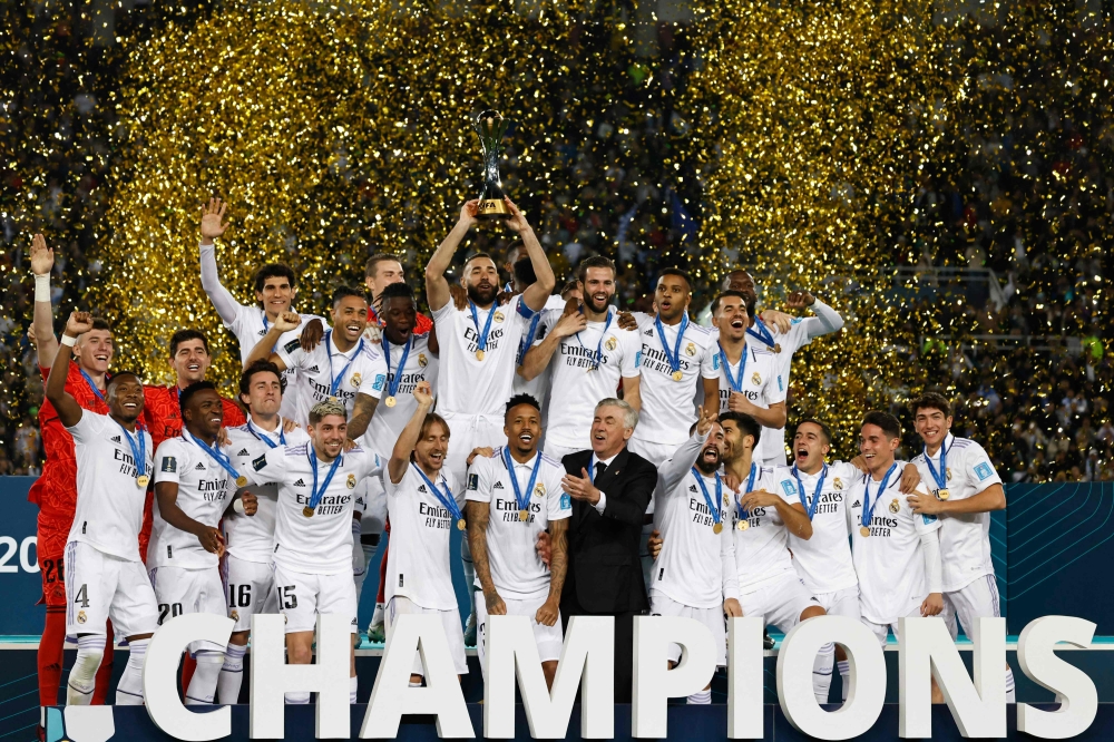 Real Madrid's players celebrate with the trophy at the end of the FIFA Club World Cup final football match between Spain's Real Madrid and Saudi Arabia's Al-Hilal at the Prince Moulay Abdellah Stadium in Rabat on February 11, 2023. - Real Madrid lifted the Club World Cup for a record fifth time with a pulsating 5-3 win over Al-Hilal. (Photo by Khaled DESOUKI / AFP)